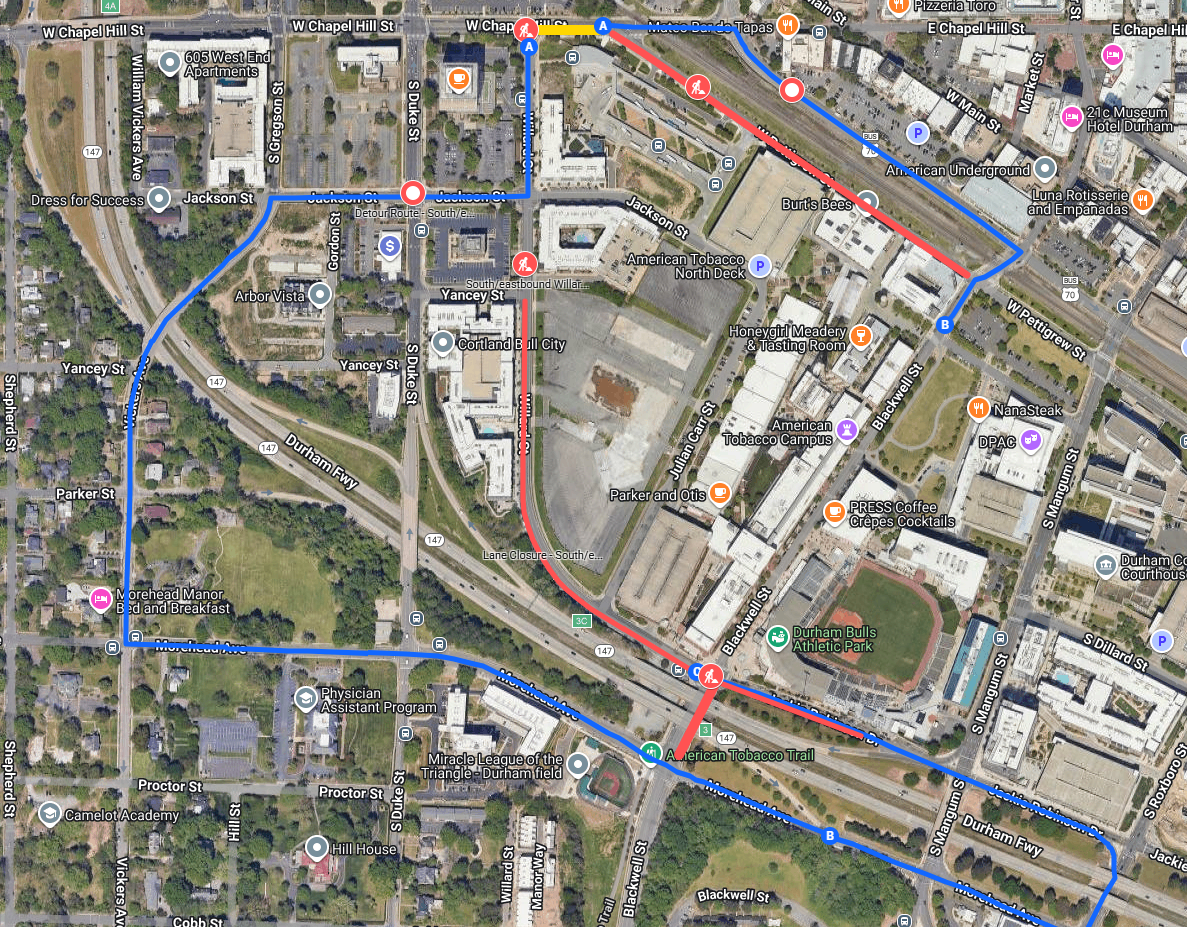 Aerial map of downtown Durham showing red closure segments and blue detour routes.