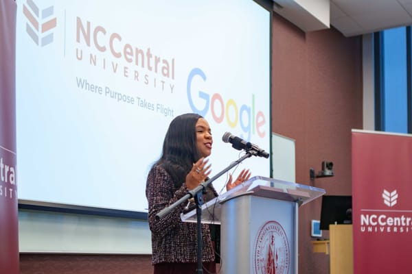 NCCU Chancellor Karrie G. Dixon at a lecturn in front of screen promoting the partnership between NCCU and Google.